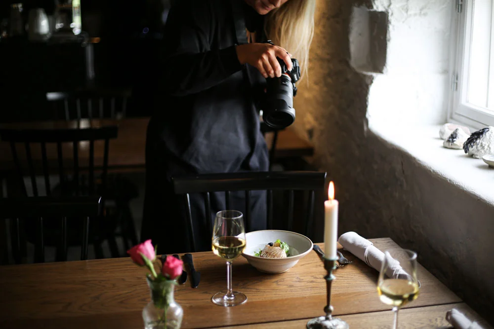 Linda taking pictures of a dish with her camera