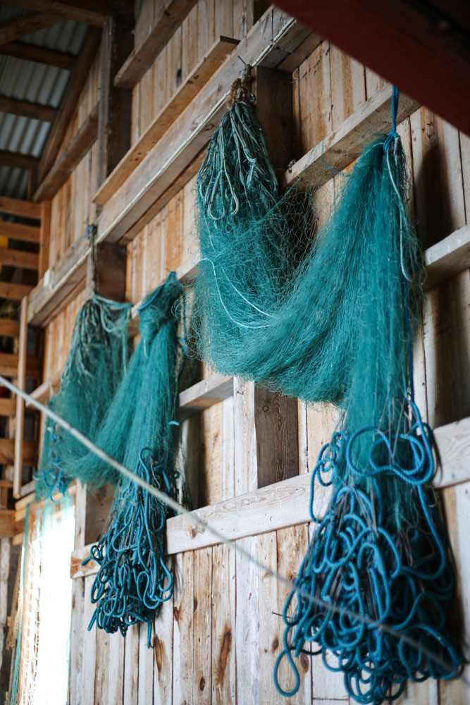 Blue fishing nets on a wooden wall
