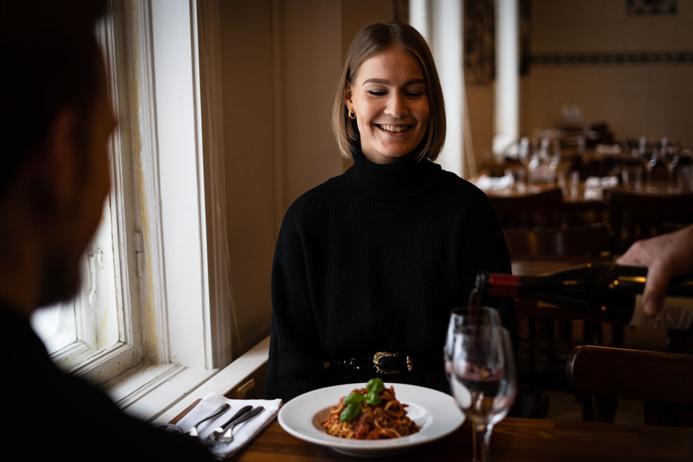 A girl smiling on an italian restaurant